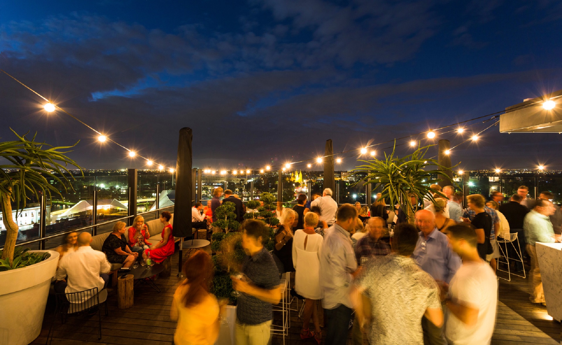 people enjoying themselves at rooftop bar, 2KW on a summer evening
